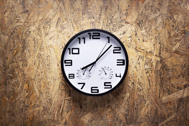 istock Clock watch on wood chipboard of wall surface background texture 1344821062