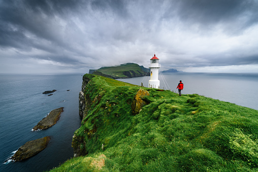 Hiking in Mykines Island near Holmur Lighthouse, Faroe Islands