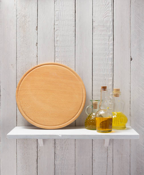 bottle of oil on shelf at wooden background pizza cutting board and oil at shelf on  wooden background plate rack stock pictures, royalty-free photos & images