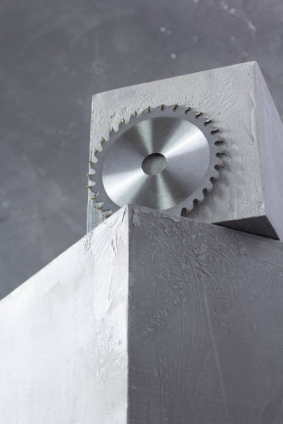 istock Circular saw blade on concrete cube or cement block and wall background 1344825875