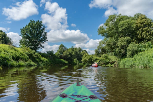 istock Canoeing on a quiet river. Journey in kayaks on the river. Active rest on the water. 1344827041