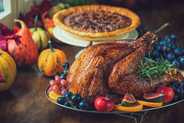 istock Preparing Stuffed Turkey with Side Dishes for Holidays 1344827095