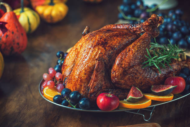 istock Preparing Stuffed Turkey with Side Dishes for Holidays 1344827102
