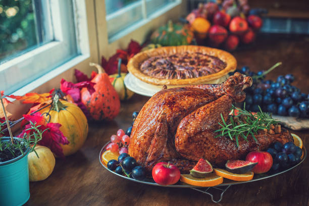istock Preparing Stuffed Turkey with Side Dishes for Holidays 1344827113