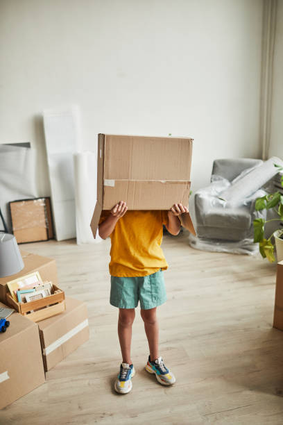 istock Boy Hiding in Box at New House 1344828049