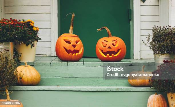 House With Halloween Orange Pumpkin Decoration Jack O Lanterns With Spooky Faces On Porch Stock Photo - Download Image Now