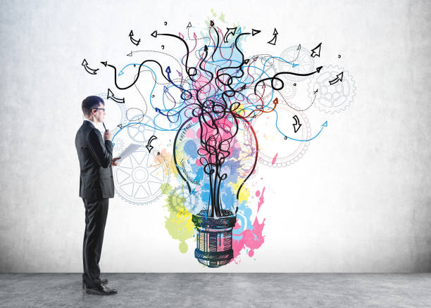istock Businessman in formal suit is looking at colourful sketch 1344834520