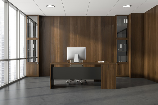 Dark office room interior with panoramic window with city skyscraper view, desktop, armchair, wooden wall, desk, shelf with folders and concrete floor. Perfect place for working process. 3d rendering
