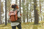 istock Young Woman with Backpack Outdoors 1344837084