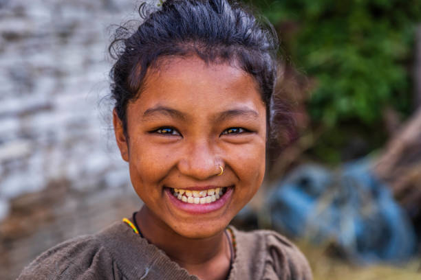 Happy Nepali girl  in village near Annapurna Range Portrait of happy Nepali girl  in village in Annapurna Conservation Area. annapurna circuit photos stock pictures, royalty-free photos & images