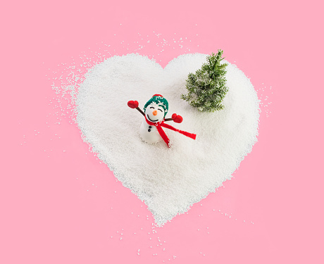 Red Valentine in white snow. Valentines day card, February 14 background. Red frozen heart on snowy background