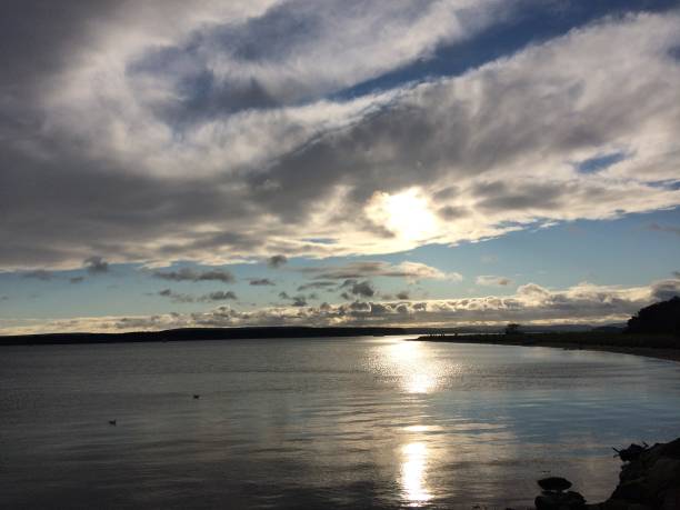 istock Spectacular clouds over lake at Poole park, England 1344843859