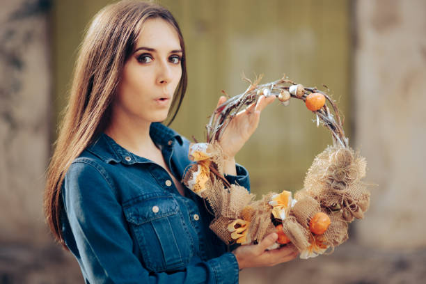 istock Funny Woman Holding a Decorative Autumn Wreath 1344844762