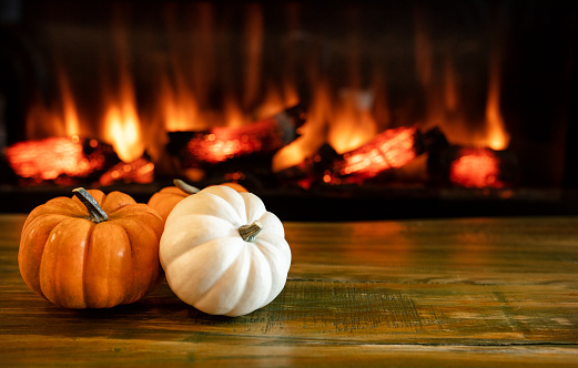 halloween pumpkins on green wooden floor  with free space and blury fireplace in background. Halloween concept