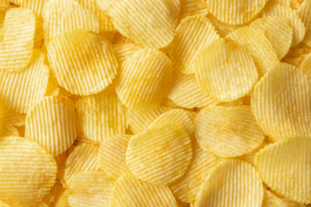 istock crispy golden potato chips snack texture background 1344850212