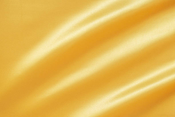 istock Abstract luxury gold fabric with soft wave texture background 1344850523