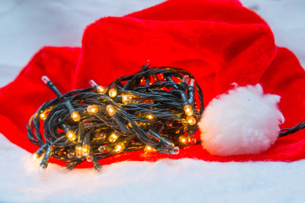 istock Christmas decorative lights with a red hat on a white background 1344853860