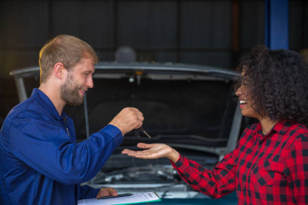 istock A female customer get car key from mechanic engineer. 1344856367