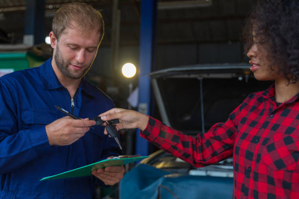 istock A female customer get car key from mechanic engineer. 1344856374