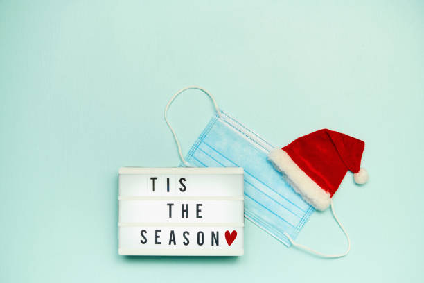 istock Christmas Message in Lightbox with Protective Mask and Santa Hat 1344859720