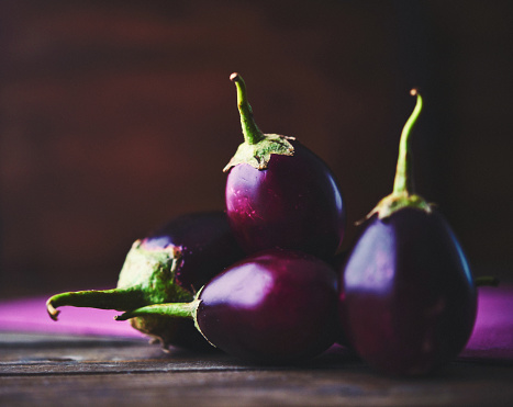 Collection of Baby Eggplant on Rustic Wood Table