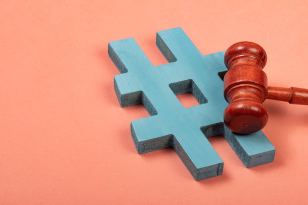 istock hashtag and justice hammer symbolizing cyber crimes 1344860545