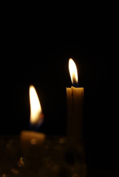 istock Two candles light at dark room 1344861416