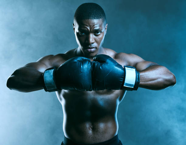 istock Studio shot of a handsome young man boxing against a blue background 1344864084
