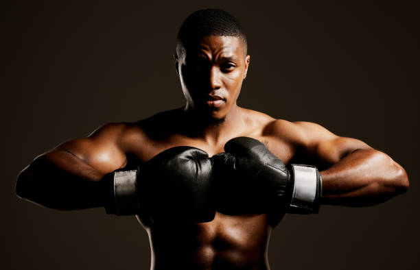 istock Studio shot of a handsome young man boxing against a black background 1344864241