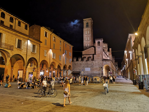 People by night in Via Zamboni, a busy street in Bologna Historical centre, 1 km long and running through the whole university area. Emilia-Romagna, Italy.