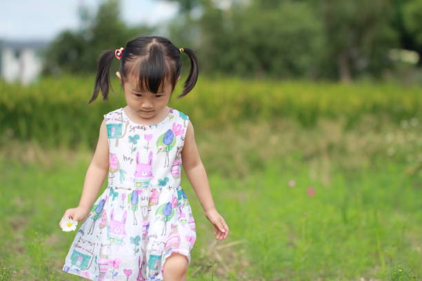 istock smiling Asian girl playing in paddy. 1344865378