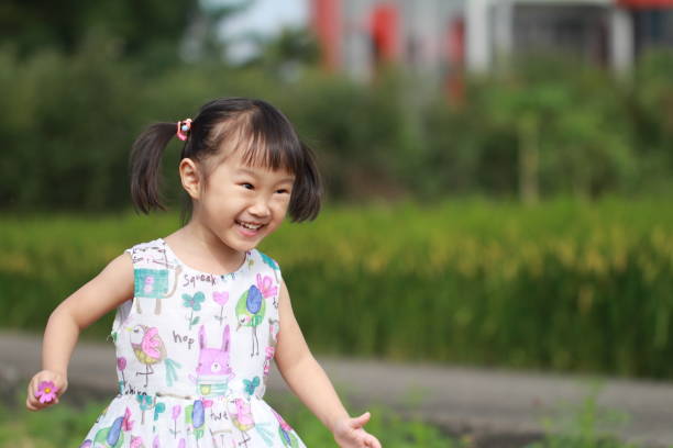 istock smiling Asian girl playing in paddy. 1344865424