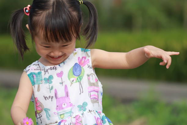 istock smiling Asian girl playing in paddy. 1344865583