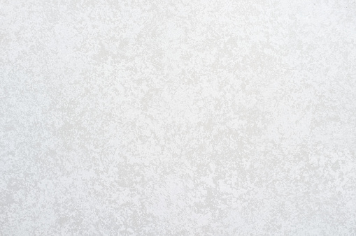 Mottled white concrete wall background.