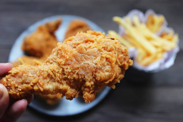 istock Woman holding  fried chicken,Top view. 1344869833