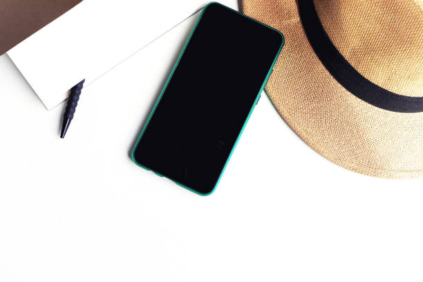 istock Straw hat and mobile phone on white background. 1344870668