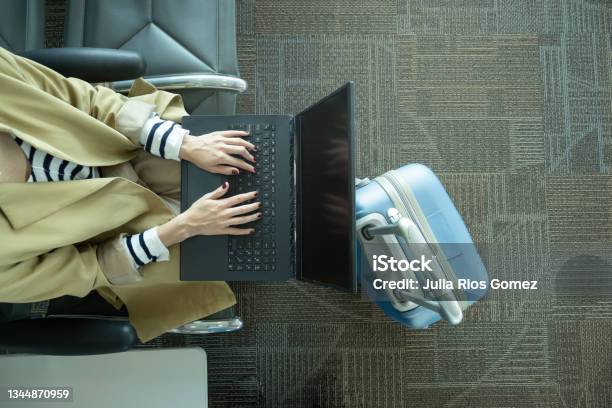 Closeup Shot Of Unrecognizable Woman Working With Laptop At Airport Next To Luggage Stock Photo - Download Image Now
