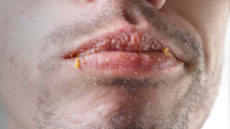 Close-up. Male mouth is eating potato chips. Junk food concept