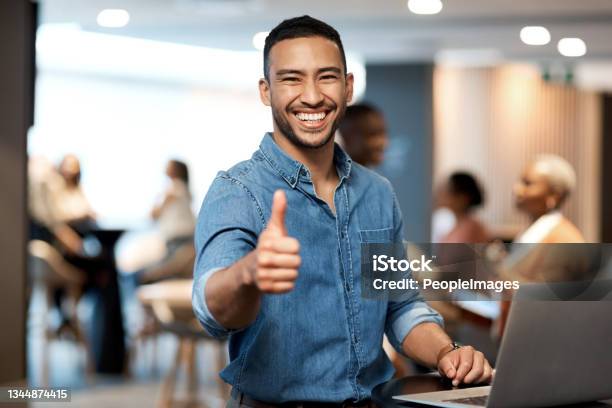 Shot Of A Young Businessman Showing Thumbs Up While Using A Laptop At A Conference Stock Photo - Download Image Now