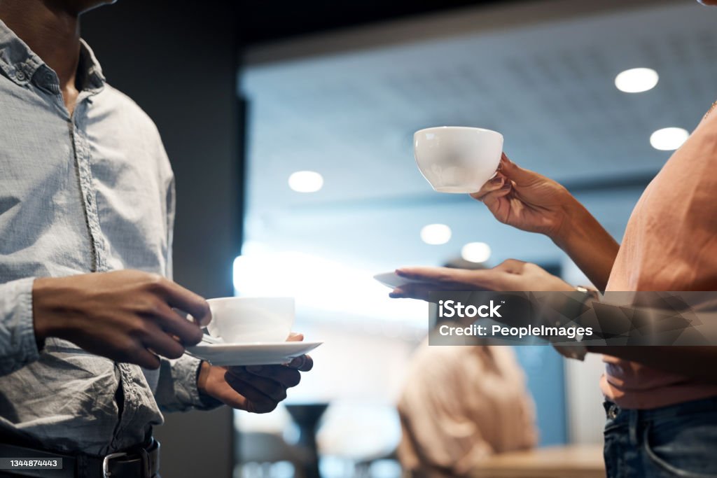 Shot of two unrecognisable businesspeople having coffee at a conference Tell me about your achievements over some tea Coffee - Drink Stock Photo