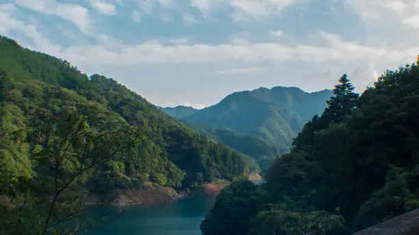 Mountains reflected on the green lake in Fujino, Kanagawa, Japan.