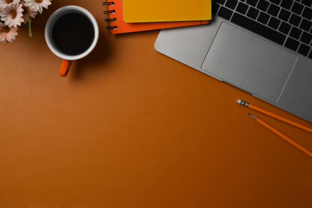 istock Top view cup of laptop computer, coffee and notebook on brow leather. 1344878959