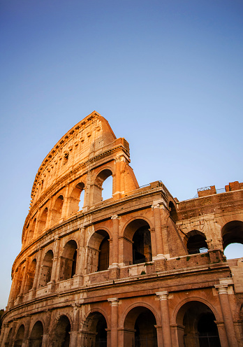 Part of Colosseum in Rome with sunlight upper section in Rome, Italy