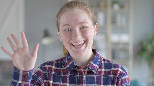 istock Young Woman Waving At the Camera 1344883379