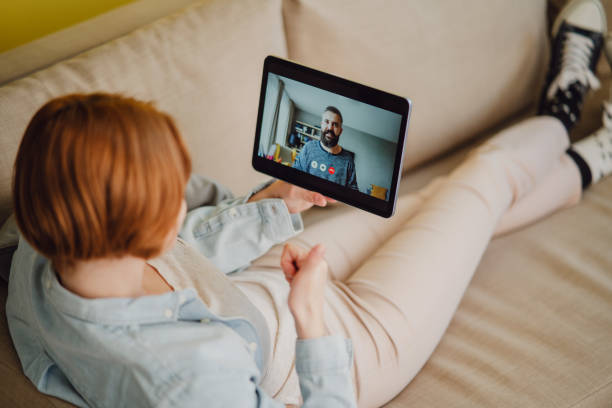 istock Young woman at home making video call using tablet, social networks concept. 1344883658