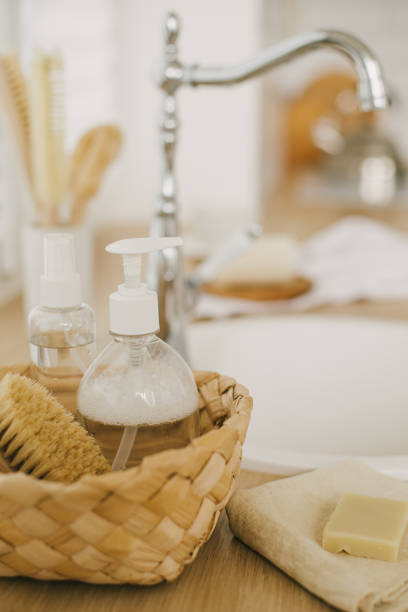 istock Kitchen interior with natural eco-friendly zero waste cleaning items: brushes, rugs, soap, spray and sponges in a wicker basket. 1344883963