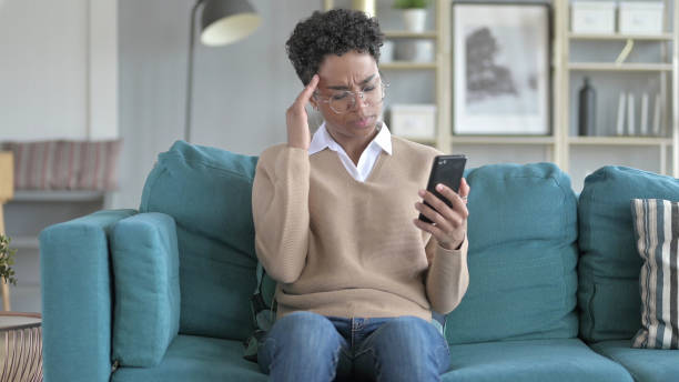 istock Young African Girl get Stressed while Scrolling The phone 1344884639