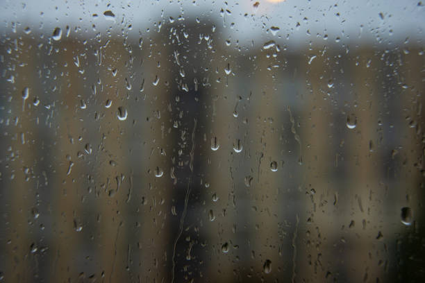 istock Wet window glass with raindrops cold weather 1344884997