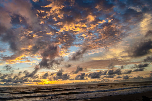 istock Colour play of clouds and sun on the beach 1344885040