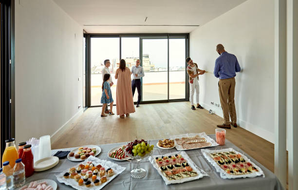 istock Real Estate Agent Interacting with Prospective Buyers at Open House 1344886169